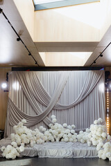 Elegant floral backdrop with draped fabric for a wedding celebration