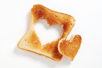 Toasted bread with cut out heart-shaped slice