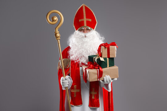 Saint Nicholas with gifts and crozier on light background