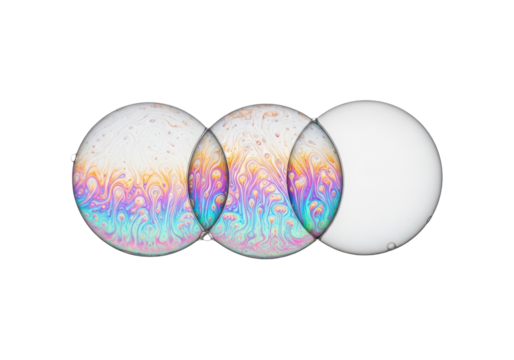 Macro photo of three pristine, spherical soap bubbles displaying iridescent spectral colors and swirling patterns against a high-key white background with copy space. Concept of scientific fragility