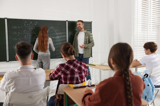 Teacher and students during lesson in classroom