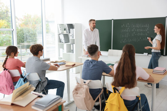 Teacher and students during lesson in classroom