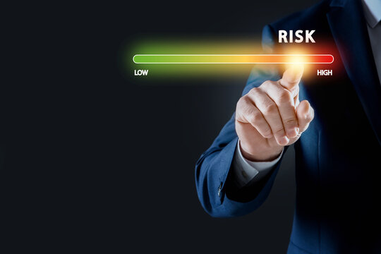 Man regulating level of risk on virtual screen against black background, closeup