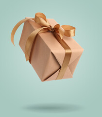 Gift box falling on pastel turquoise background. Present