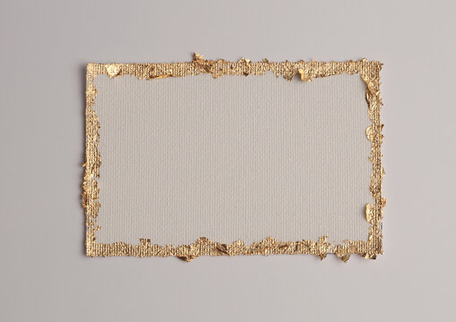 Gold (bronze) glitter empty canvas frame on beige gray paper background. Abstract copy space texture.