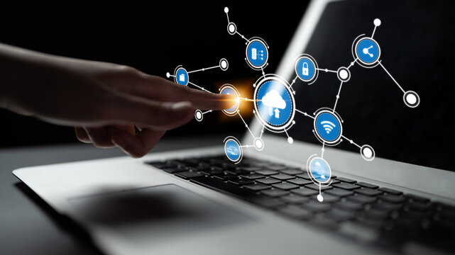 A captivating image illustrating the concept of cloud computing, showing a hand interacting with digital icons on a laptop against a dark backdrop, symbolizing innovation and connectivity. Tessel