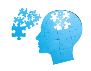 Silhouette of a head shaped from jigsaw pieces, with puzzle elements scattered