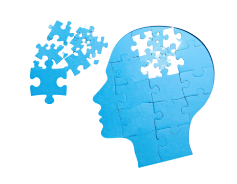 Silhouette of a head shaped from jigsaw pieces, with puzzle elements scattered