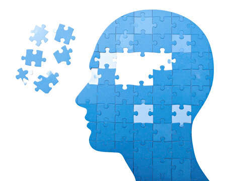 Conceptual image of a human head formed by jigsaw puzzle pieces, some missing