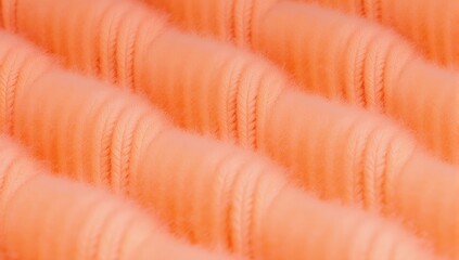Peach colored knitted fabric texture close up detailed background for design