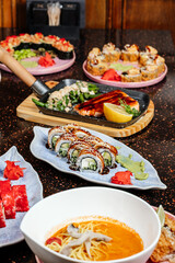 A variety of sushi sets displayed together in one image, showcasing assorted rolls, nigiri, and garnishes in a colorful and appetizing arrangement.