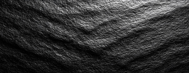 Horizontal black paper background with a luxurious and glossy finish. Features subtle textures of