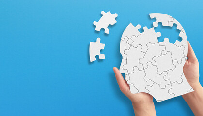 Head and brain diseases concept. A missing pieces of the brain puzzle on blue background.