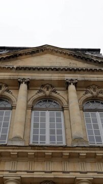 grand building with columns, imposing architectural design with symmetrical features and decorative elements