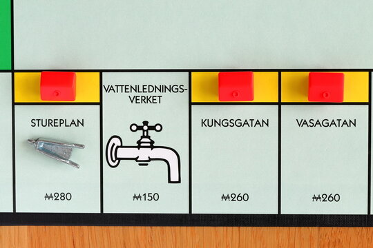 Monopoly board game. The yellow streets with red hotels. Swedish text for Stureplan, Kungsgatan and Vasagatan. Fun for the whole family. Above angle shot photography.