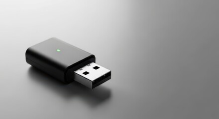 Presenting USB adapter for connecting devices wirelessly, a sleek black device on clean surface. USB adapter is designed for seamless connectivity, shown with indicator light and metallic plug.