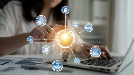 A business professional engages with digital technology graphics, emphasizing data analytics and innovation to foster growth and success in a modern work environment. Crux