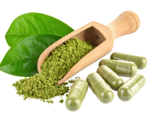 Image showing green powder in a wooden scoop next to capsules with two leaves