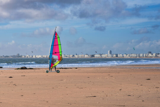 Windsurfing with wheels on the beach at Pornichet and La Baule in Brittany, France, in front of the sea and buildings typical of the region