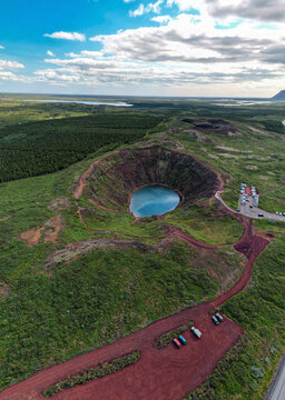 Aerial view of the striking contrast of the red volcanic rock against the turquoise water of Kerio Crater, Klausturholar, Gr&iacute;msnes- og Grafningshreppur, Iceland.