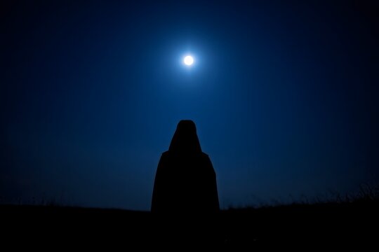 Silhouette of a Person in a Hooded Cloak Gazing at the Full Moon - Powered by Adobe