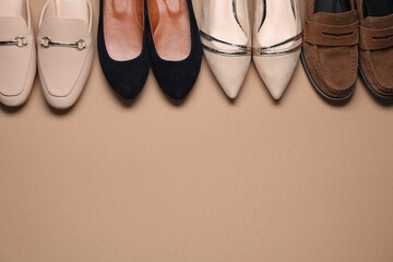 Different stylish shoes on beige background, flat lay. Space for text