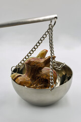 Jade rabbit figurine on balance scale symbolizing value weighing closeup.