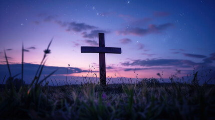 silhouette of christian wooden cross at twilight with dramatic purple and blue sunset sky