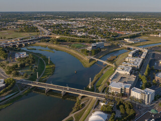 Aerial view of the confluence of rivers, with bridges spanning the waterways and buildings lining the banks, reflecting the sky in the water, Dayton, OH, United States.