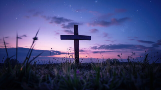 silhouette of christian wooden cross at twilight with dramatic purple and blue sunset sky