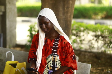 young african lady using smartphone