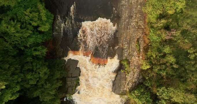 Top down shot of a waterfall in full spate