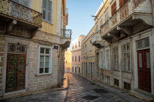 Beautiful venetian architecture of a limestone paved street in Ermoupoli on the Greek island of Syros