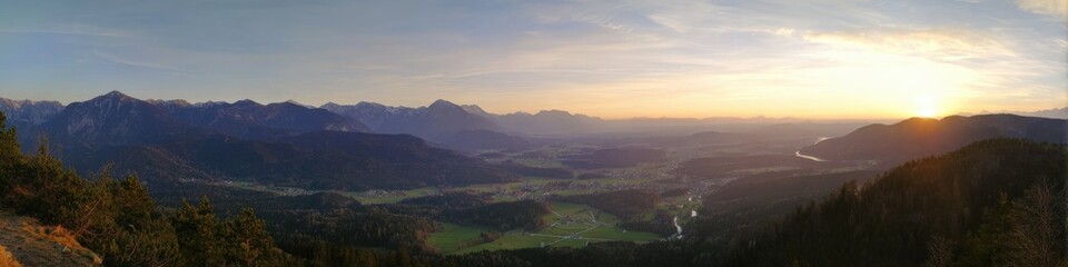 Fototapeta premium Breathtaking mountain valley at sunrise with expansive landscape and distant peaks