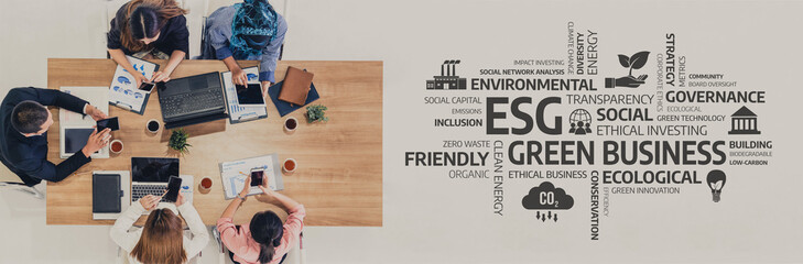 A collaborative workspace showcasing a diverse group of professionals discussing ESG concepts,...