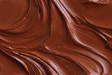 Brown cocoa cream swirl background texture. Delicious chocolate icing or frosting. Sweet confectionery treat and patisserie item for dessert concept.