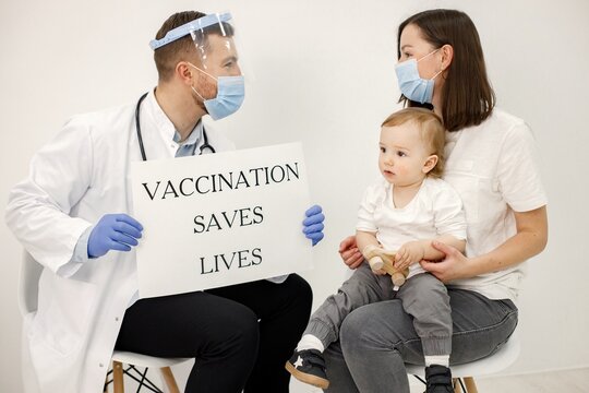 Little boy, mother and male doctor holding a poster about vaccination