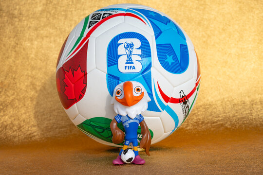 ZHONGSHAN China-November 17 2025: mascot Clutch and the soccer for the 2026 FIFA World Cup on a golden background at horizontal composition.