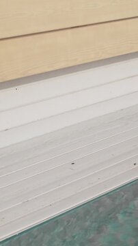 Process of opening a pool with an automatic roll-up cover. Video shows how the white slats roll up neatly, revealing the clear water of the pool. A modern automation system for convenience and safety
