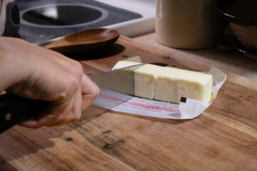 Cutting a stick of butter into quarters