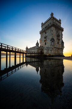 Belem Tower (Tower of Saint Vincent) reflecting in the lagoon-like water of the Tagus River surrounding it in Lisbon, Portugal.	
