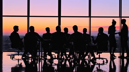 a captivating silhouette of a business meeting at sunset, symbolizing corporate collaboration and strategic decision-making in a high-rise setting
