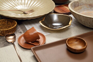 Close-up of sophisticated table settings with plates, cutlery, bowls, and glasses for beautiful events and dinners.