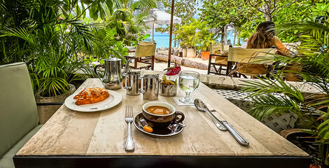 View of a breakfast on a terrace by Seven Mile Beach in the Caribbean, Grand Cayman