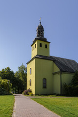 Fototapeta premium Vertical Tall View of the Roman Catholic Church in Modliszewko, Gniezno Commune, Greater Poland Voivodeship, Poland with Brick Walkway.