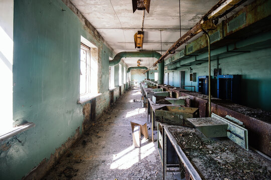 Old abandoned industrial workshop of radio equipment with remnants of furniture