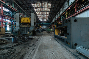 Fototapeta premium Abandoned factory. Large empty ruined industrial hall with broken remnants of equipment