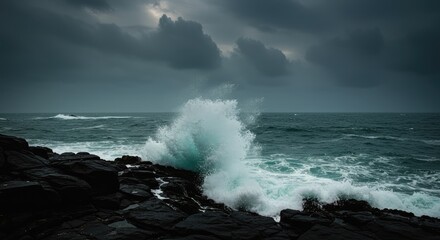 A powerful wave crashes against dark rocks on a stormy sea