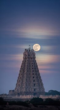 Beautiful view of the annamalaiyar temple with a full moon in tiruvannamalai, india.