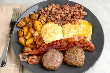 eggs over easy with home fries and corn beef hash